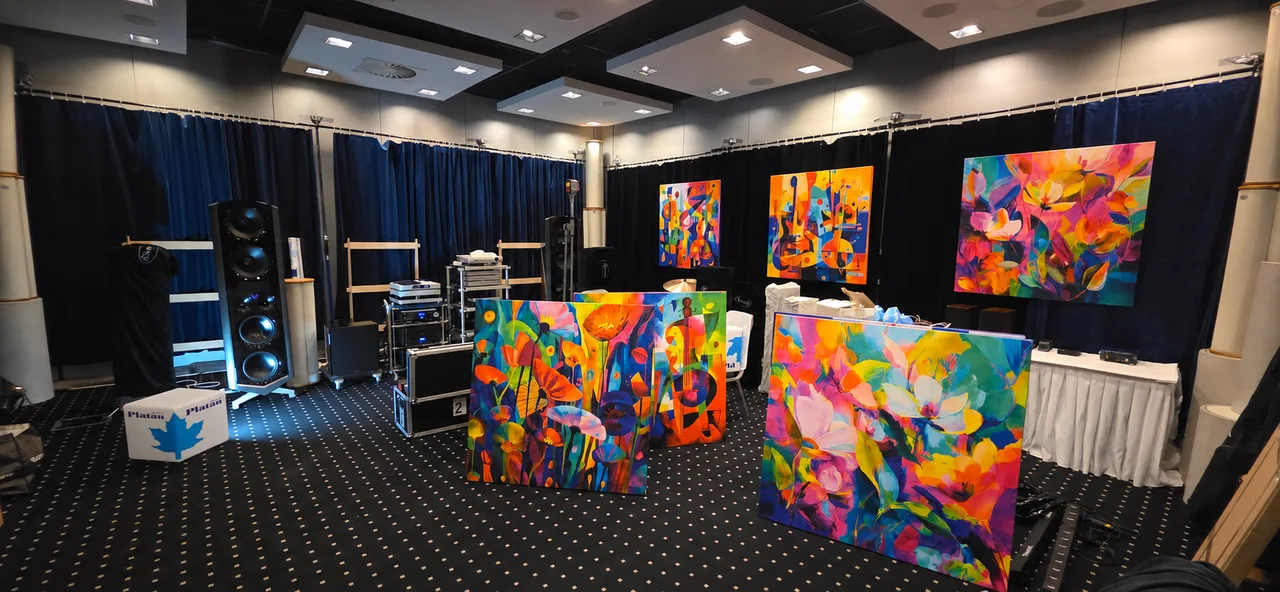 Six colourful floral and music-inspired canvas prints displayed together in a customer’s audio exhibition room.